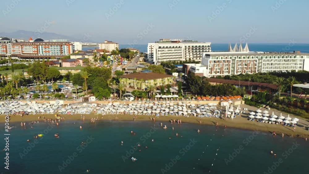 Aerial view of people crowd relaxing on beach and sea with waves. Top view from flying drone. Aerial view of people crowd relaxing on beach and sea with waves. Top view from flying drone.