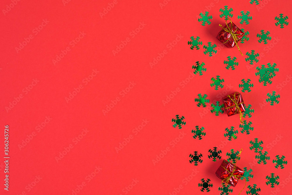 christmas composition of gifts and toys on red background. Winter wedding design. Flat lay, top view. Freeplace for text.
