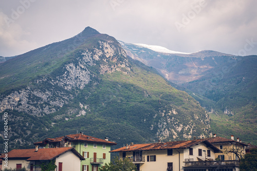 View of Italian town Arco, buildings and mountains. Snow on the top. © David Pastyka