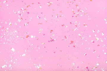 Pearl confetti on pink background.