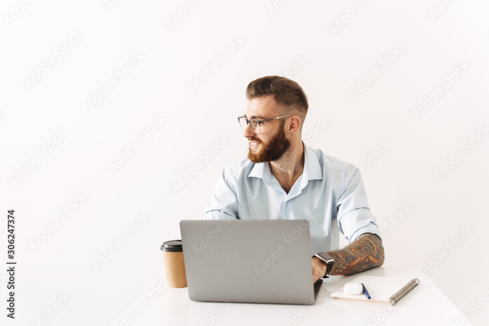 Cheery optimistic young businessman using laptop computer Cheery optimistic young businessman using laptop computer