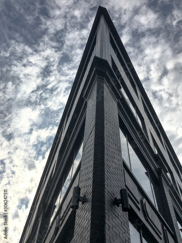 Wallpaper Mural Corner of a building against a cool blue sky and clouds background Torontodigital.ca