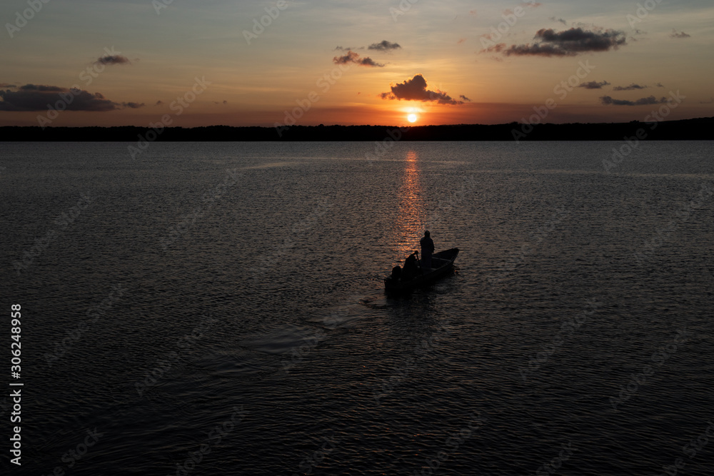 Silhouette of boat on the river at sunset Silhouette of boat on the river at sunset