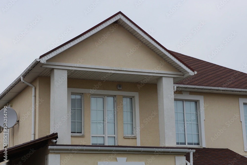  house with windows on a brown wall 