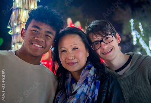 фотографія Asian mother, African American mixed son, and caucasian step son with Christmas lights