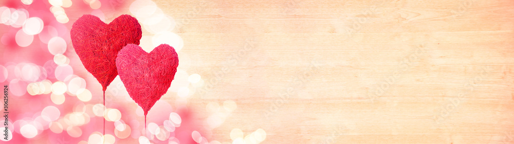 Valentines day background panorama banner long - 2 red pink hearts balloons and bokeh lights on rustic bright wooden texture
