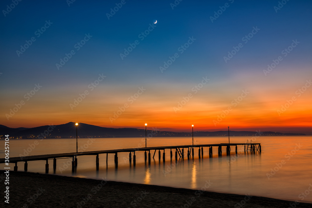 Sunset at beach with new moon Sunset at beach with new moon