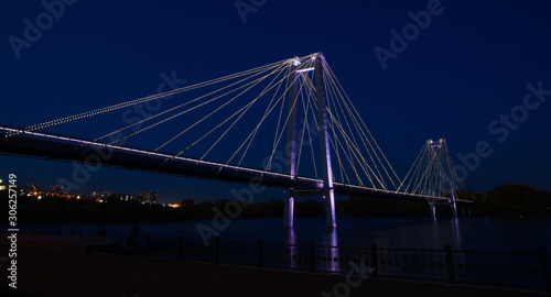 glowing bridge over the river in the night city