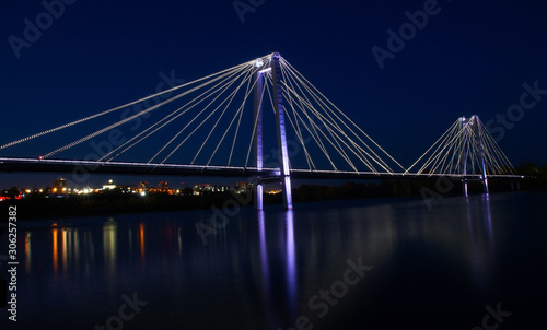glowing bridge over the river in the night city