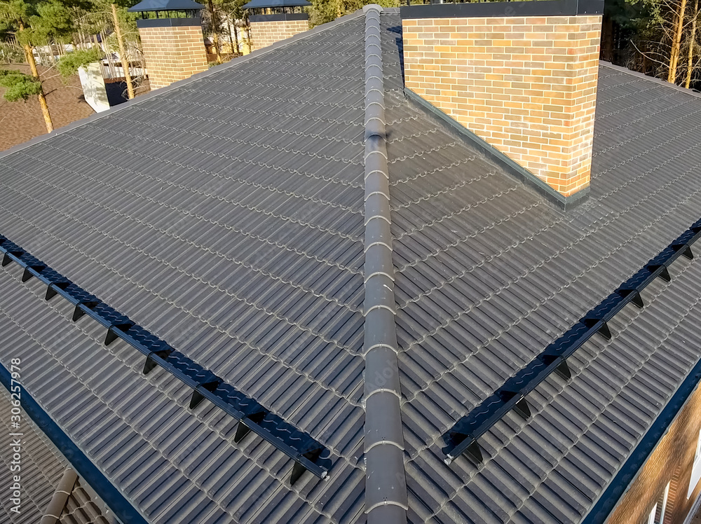 House with ceramic tile roof. cementsand roof tiles. Stock Photo