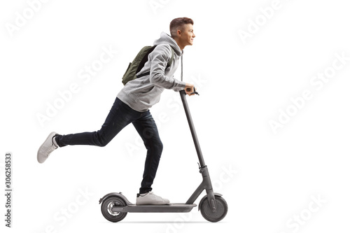 Fotografia Male student with a backpack riding an electric scooter