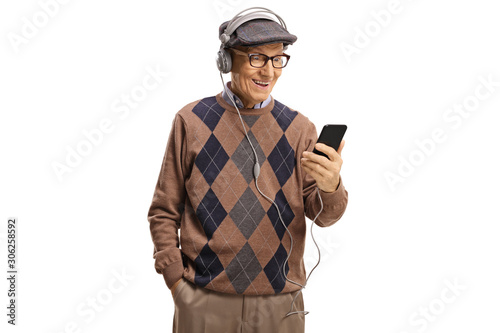 Elderly man listening to music from a mobile phones with headphones © Ljupco Smokovski