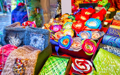 Creative and bright handmade clothes for sale at stalls during Riga Christmas market in Latvia. Europe on winter. Street Xmas and holiday fair. Advent Decoration and Stalls with Crafts Items of Bazaar © Roman Babakin