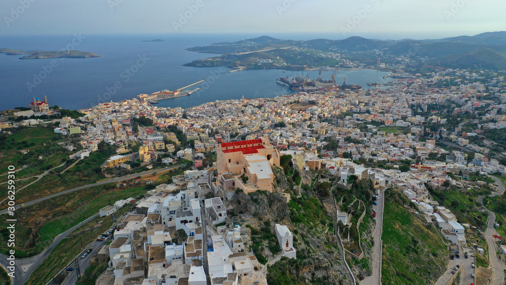 Obraz premium Aerial drone photo of iconic uphill catholic settlement of ano Syra featuring church of Saint George with beautiful colours, Syros or Siros island, Cyclades, Greece