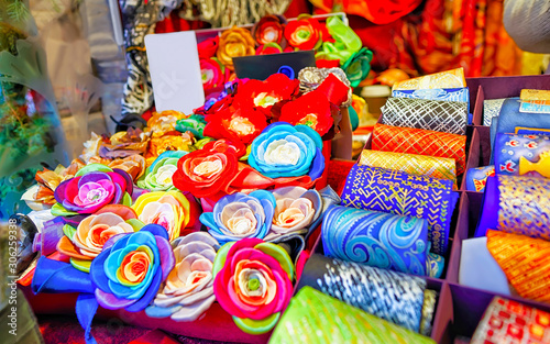 Creative and bright handmade clothes for sale at stalls during Riga Christmas market in Latvia. Europe on winter. Street Xmas and holiday fair. Advent Decoration and Stalls with Crafts Items of Bazaar
