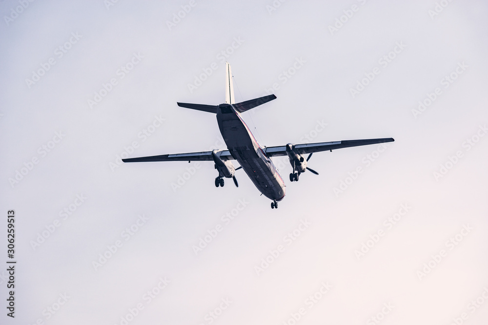 Landing of the passenger retro plane in the clear sky.