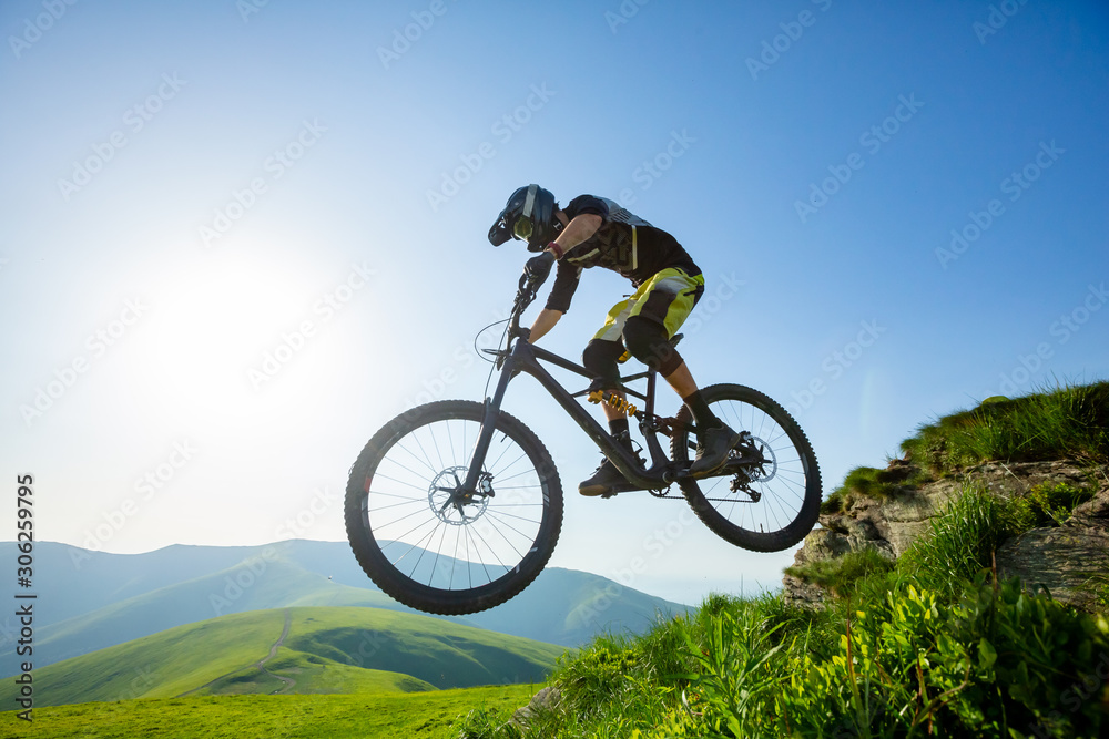 Professional rider is jumping on the bicycle.