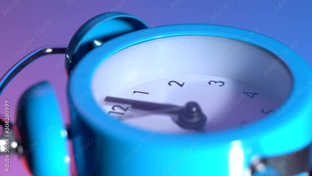 The alarm clock rotates on a colored background. At 00:00 hours The alarm clock rotates on a colored background. At 00:00 hours