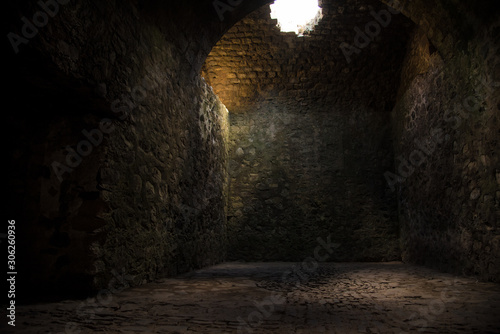 Interesting View from the inside of a dark room dungeon  with natural light entering from outside