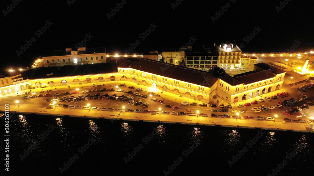 Aerial drone night shot of famous port and illuminated town of Ermoupolis in island of Syros or Siros, Cyclades, Greece