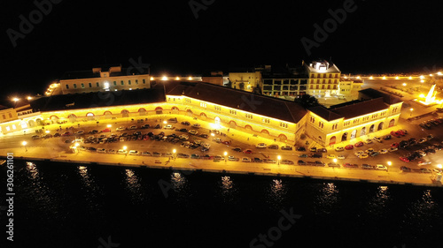 Aerial drone night shot of famous port and illuminated town of Ermoupolis in island of Syros or Siros, Cyclades, Greece