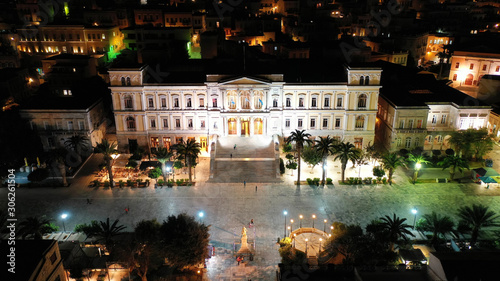 Aerial drone night shot of neoclassic landmark building of Ermoupolis town city hall in Miaouli square, Syros or Siros island, Cyclades, Greece
