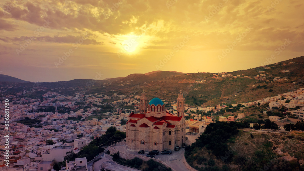 Aerial drone photo of iconic church of Agios Nikolaos in famous district of Vaporia in main town of Syros island - Ermoupolis at sunset with beautiful golden colours, Cyclades, Greece