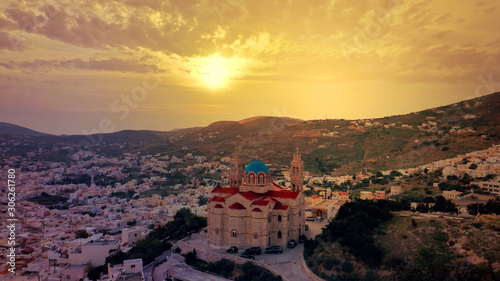 Aerial drone photo of iconic church of Agios Nikolaos in famous district of Vaporia in main town of Syros island - Ermoupolis at sunset with beautiful golden colours, Cyclades, Greece