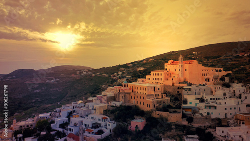 Aerial drone photo of iconic uphill Catholic settlement of ano Syra featuring church of Saint George at sunset with beautiful colours, Syros or Siros island, Cyclades, Greece photo