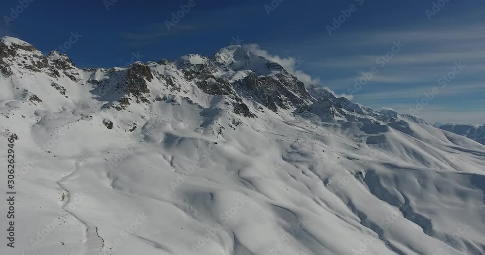 High mountains with fresh snow in sunny winter day. Freeride on off piste slope. Top aerial view. Caucasus Mountains, Georgia, ski, Tetnuldi, Alps. Svaneti High mountains with fresh snow in sunny winter day. Freeride on off piste slope. Top aerial view. Caucasus Mountains, Georgia, ski, Tetnuldi, Alps. Svaneti