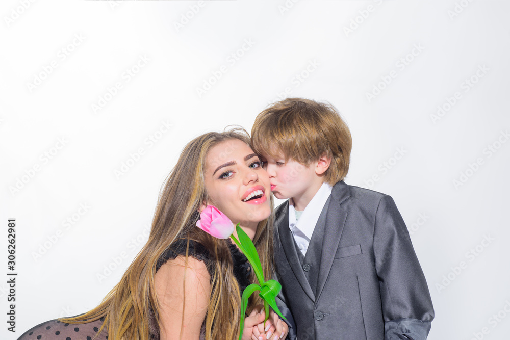 Flower as present. Boy giving flower for sister. Happy family celebrating. Son give his mother beautiful tulip. Boy presents mother flower. Flowers for mom on birthday. Son greeting mom with birthday. Flower as present. Boy giving flower for sister. Happy family celebrating. Son give his mother beautiful tulip. Boy presents mother flower. Flowers for mom on birthday. Son greeting mom with birthday.