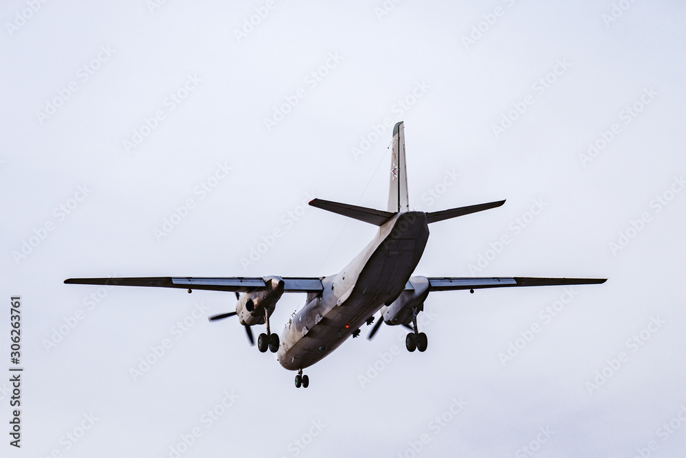 Landing of the freight military plane in the clear sky at evening time. Landing of the freight military plane in the clear sky at evening time.