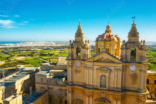 Mdina city - old capital of Malta. Aerial nature landscape, sunny day, blue sly, winter, a lot of green grass, field. Malta country