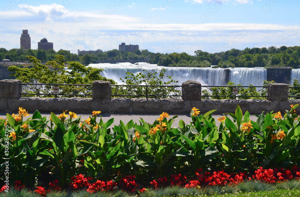 contrast of a beautiful garden facing Niagara Falls from the Canadian side and the view of the USA in the background contrast of a beautiful garden facing Niagara Falls from the Canadian side and the view of the USA in the background