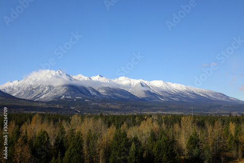 The wonderful train journey from Jasper to Vancouver in British Columbia, Canada in Autumn.  With train, trees, foliage and snow capped mountains