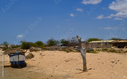 old boat next to a rustic cabin in the middle of the Colombian guajira, northernmost point of South America