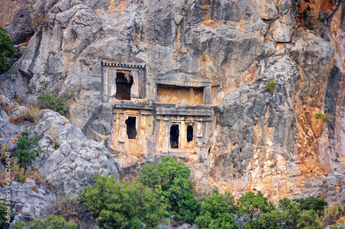 Summer mediterranean cityscape - view of the ruins of ancient Greek tombs in the ancient city of Myra, near the Turkish town of Demre, Antalya Province in Turkey