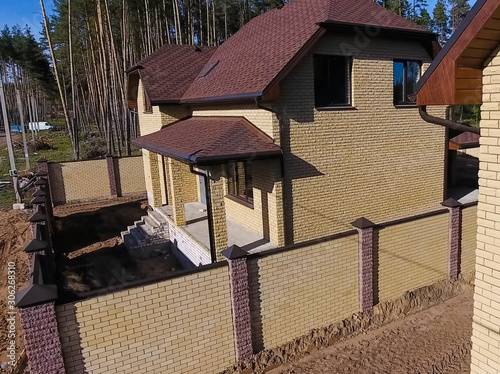 Bituminous tile for a roof. House with a roof from a bituminous photo