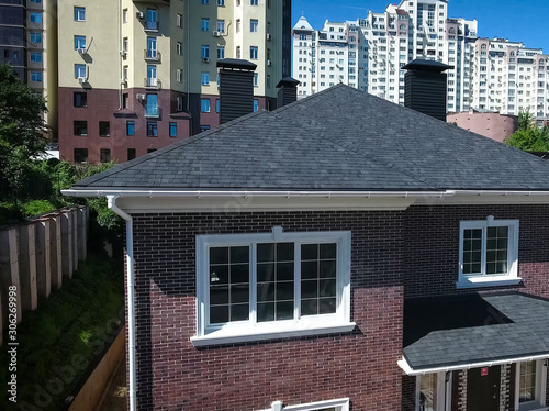 Bituminous tile for a roof. House with a roof from a bituminous photo