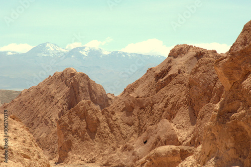 Desert rocks with snow capped moutains in the distance