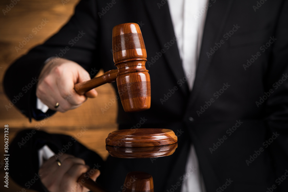 Justice and law concept, Male judge in a courtroom striking the gavel Justice and law concept, Male judge in a courtroom striking the gavel