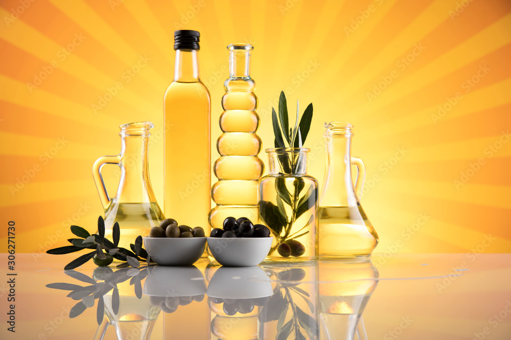 Bottles with organic cooking olive oil and olive branch Bottles with organic cooking olive oil and olive branch