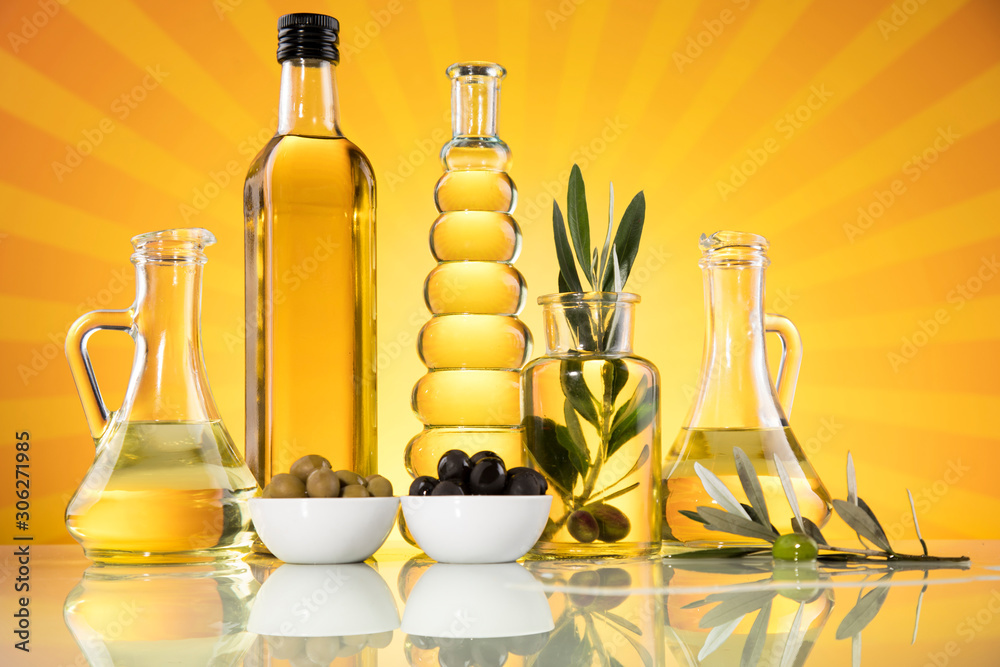 Bottles with organic cooking olive oil and olive branch