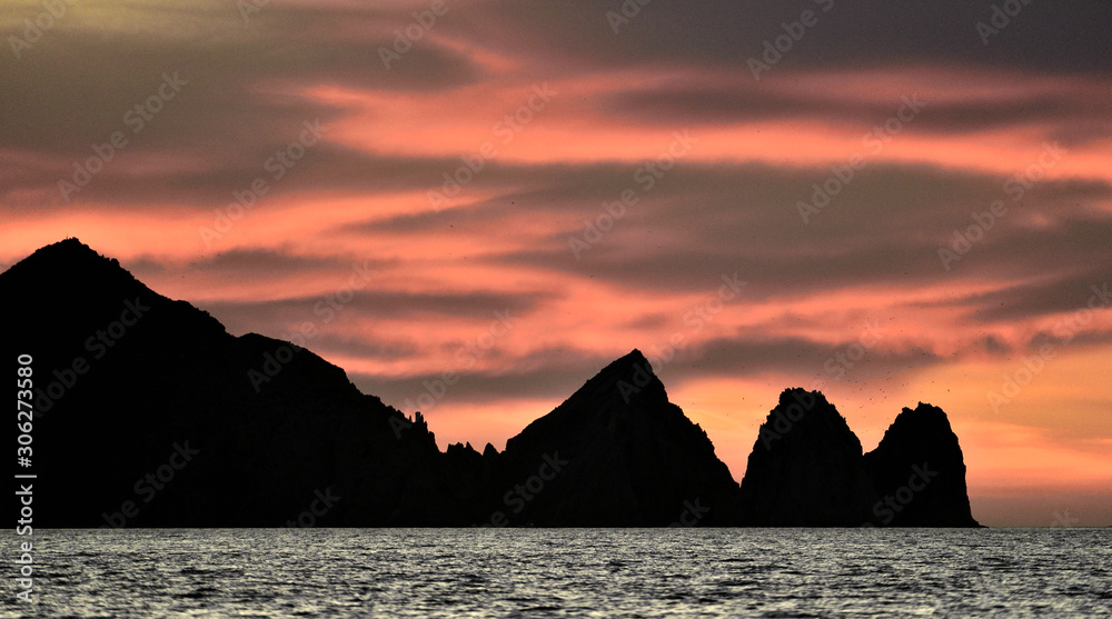 Beautiful Sunset of Seascape with Mountains silhouets. Sea off the Coast of Cabo San Lucas. Gulf of California (also known as the Sea of Cortez, Sea of Cortes. Mexico.