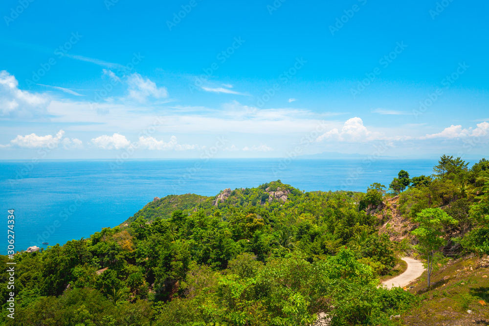 Natural Landscape View of Stone Mountain and Tropical Beach against Blue Sky and Clouds