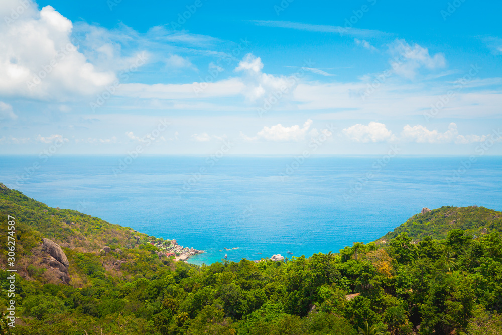 Fototapeta premium Natural Landscape View of Stone Mountain and Tropical Beach against Blue Sky and Clouds