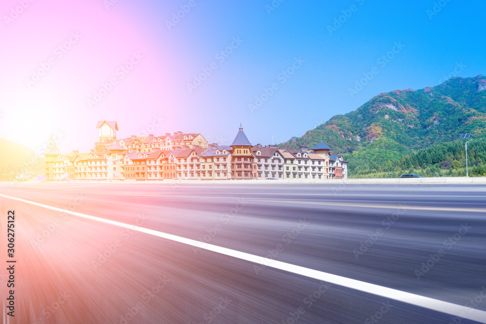 Blue sky mountain european-style castle building and asphalt highway