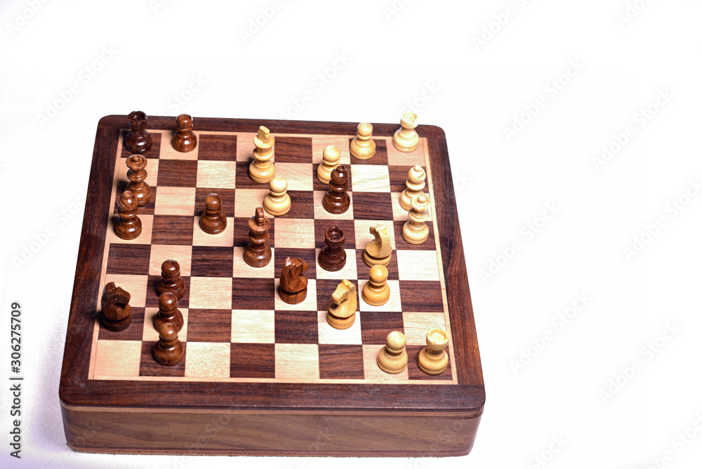 Top angle shot of chess pieces on chessboard against white background. Wooden chess pieces. Top angle shot of chess pieces on chessboard against white background. Wooden chess pieces.