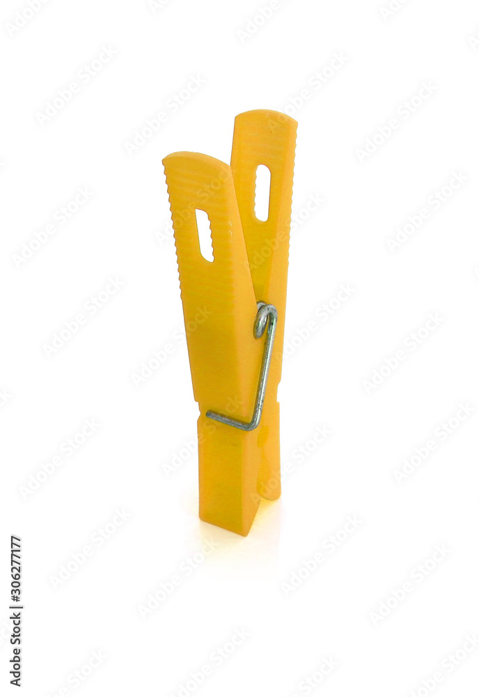 Isolated yellow plastic clothespin on white background. Isolated yellow plastic clothespin on white background.