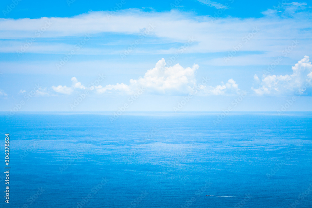 Background Texture of Ocean Skyline with Tropical Beach against Blue Sky and White Clouds in Summer Sunny Day